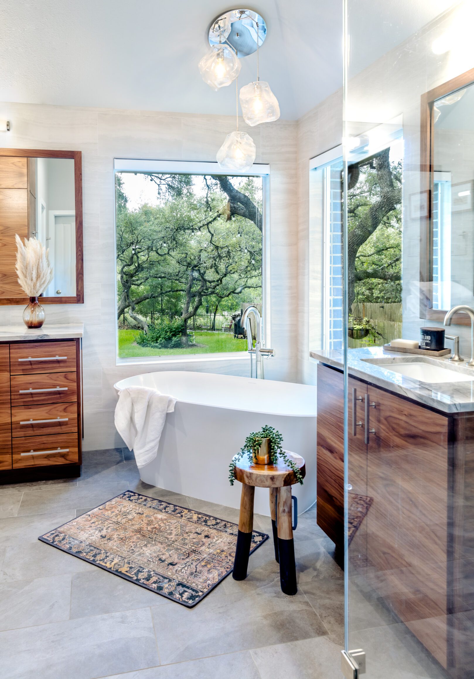 austin organic modern luxury bathroom remodel freestanding tub custom walnut vanity chandelier